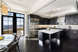 The texture and detail of the quartz immediately draws your eye to the center island, while additional finishes like the subway tile backsplash and wooden range hood bring in subtle accent colors. 35 Luxury Kitchens With Dark Cabinets Design Ideas Designing Idea