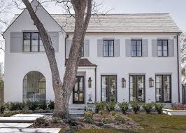 Wood color for cozy and elegant look. White Brick Painted Home With Dove Gray Shutters Transitional Home Exterior