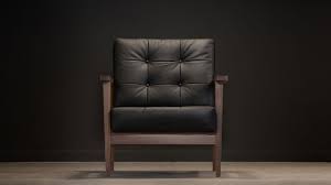 It features a chic plush dark grey suede cushion upon a black powder metal frame for ultimate relaxation, a true statement of modern sophistication. The Mid Century Show Wood Armchair Black Leather Century Modern