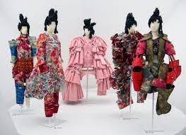 All suited with jacket and tie symbol; Comme Des Garcons Wikipedia