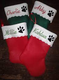 Santa claus is coming to town, and he needs a place to drop off your treats. 15 Inch Embroidered Personalized Pet Christmas Stocking Cat Or Dog Paw Pampered Paw Gifts