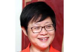 ― picture by choo choy may a pkr supporter wearing a datuk seri anwar ibrahim mask holding datuk seri dr wan azizah's poster standing next to a policeman, kajang, march 23, 2014. Malaysian Chinese Association