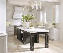 Clean kitchen design with white shaker cabinets paired with polished black granite countertops and white subway tile backsplash. White Kitchen Cabinets With A Dark Grey Island Omega