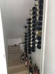 Who needs a place for coats? Diy Wine Closet Expanding Capacity Under The Stairs With Metal Wine Racks Vintageview