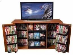 The doors of this storage cabinet open up to reveal compartments that let you store a host of things like books. Cd Storage Cabinet With Doors Ideas On Foter