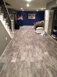 Basement Flooring Renovation Eclectically Grey From Carpet To Wood Look Tile In The Basement Check Out The Basement Flooring Flooring Waterproofing Basement