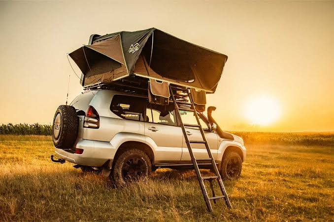 Toyota Land Cruiser Prado with double rooftop tent setup for Rwanda camping safari.