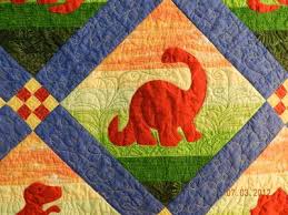 Dinosaurs is a patchwork sampler pattern featuring brachiosaurus, stegosaurus, tyrannosaurus, and triceratops blocks. Dinosaurs Quilts