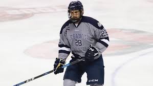 Travis Acker Receives A Pass From A Teammate Stevenson College Athletics Ice Hockey