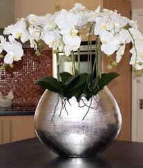 Artificial flowers have a reputation for being tacky, dusty and obviously fake. Artificial Orchids Orchid Arrangements Orchid Displays White Orchids In Silver Rough Aluminium Vase Artificial Orchids Orchid Arrangements Orchids