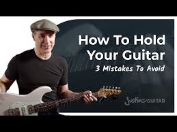 This position is what most guitar teachers learn. How To Hold Your Guitar Justinguitar Com