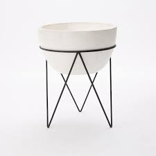 Surprisingly, with all the color variations we see on plastic items, it's rare to see a pretty plant pot. Iris White Cement Black Stand Planter