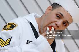 Danny Jimenez, a Naval Sea Cadet from Staten Island, takes bite of a...  News Photo