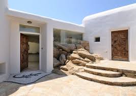 I Love How They Managed To Blend The Rocks Into The Architecture In This Hotel In Mykonos Greece Architecture House Exterior Mediterranean Home