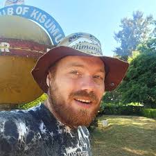 World Traveler Harry has left Kenya for Uganda! Hanging with the giraffes  and such (still sporting a cool hat purchased to avoid sunstroke at  Kilimanjaro). What an adventurer. So proud of this