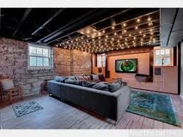 There are several ways to make unfinished basement floors look a little homier. 6 Basement Finishing Ideas That Won T Break The Bank Basement Lighting Basement Remodeling Finishing Basement