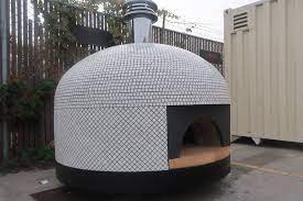 4 retractable handles on the oven for easy lifting; Commercial Pizza Ovens Custom Tiled Forno Bravo Commercial Pizza Oven Pizza Oven Outdoor Brick Pizza Oven