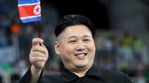 A man with an uncanny resemblance north korean supreme leader was seen beaming widely and waving the nation's flag among bemused spectators. Kim Jong Un Lookalike Proudly Waves The North Korean Flag To Show His Su