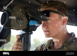 Sgt. Paul Meixner, a reconnaissance Marine with 2nd Reconnaissance  Battalion and Middlesex, New Jersey native, uses a scout sniper observation  tool to sight in at a target during an Urban Sniper Course