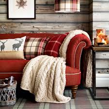 Vintage setup for a farmhouse living room in a cottage style, fitted with a large sofa sectional upholstered in a cotton fabric in a white color and decorated with a set of pink throw. Red Living Room Ideas Curl Up With This Comforting And Vibrant Colour