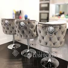 Grey upholstered bar stool with chrome lion head knocker. Lucia Lion Knockerback Barstool Black Cream Grey Pink Lush Interiors