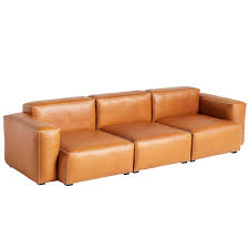 Low section of a woman relaxing upside down while reading newspaper on sofa. Hay Mags Soft Sofa 3 Seater 279 Cm Low Arm Silk 0250 Finnish Design Shop