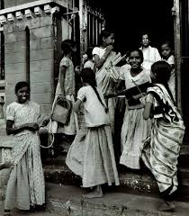 Girl students and their teacher leaving ...