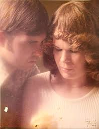 That is my Dad in front of the rose bush. It had yellow Rose's and Dad told  me it was over 100 years old. He had planted a start at his home