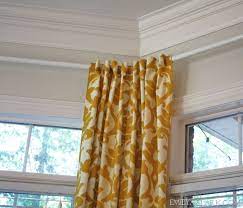 Hanging Curtains On Angled Windows Emily A Clark Hanging Curtains Bay Window Corner Window Treatments
