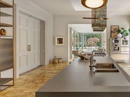 The wooden counter is attached to the white kitchen island to create a breakfast bar with gray counter chairs. Kitchen Counter Top Trends For Every Budget