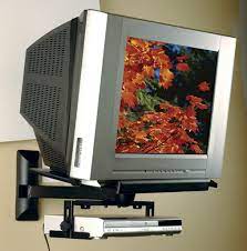 Businessman in suit with old tv instead of head keeping arms crossed while standing inside empty room with gray dark wall on background. Sanus Vmtv Crt Wall Mounts Tv Mounts And Stands Products Sanus