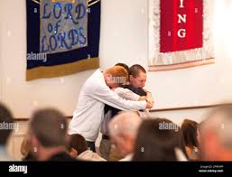 From left, Martin Brugger, Michael Baugus, and Nathan Skates hug eachother  while praying for the Cruce family