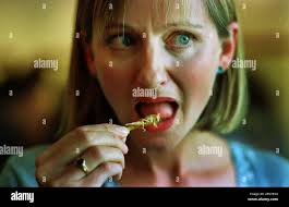VICKY HOPE-WALKER EATING A LOCUST, JULY 2000 Stock Photo