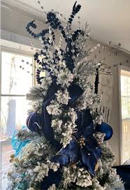 Browse 8,266 navy blue living room on houzz you have searched for navy blue living room ideas and this page displays the best picture matches we have for navy blue living room ideas in july 2021. Elegant Flocked Christmas Tree With Blue And Silver Decorations