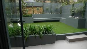 Make the border an interesting design with sleek lines. Modern Small Low Maintenance Garden Fake Grass Grey Raised Beds Contemporary Planting Battersea London London Garden Design