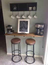 A cabinet door slides upward to uncover coffee supplies and cups. 7 Tips For Decorating The Breakfast Bar