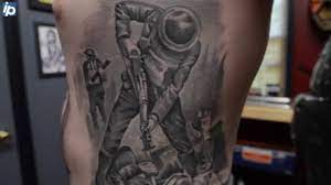 Colorful military flag tattoo on man left half sleeve. How These Marines Remember The Fallen With Ink And Metal The State