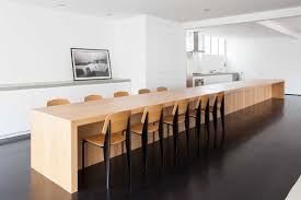 A kitchen island with table is a stylish, modern, and most importantly, functional solution to the problem of organizing a dining area. A Huge Kitchen Island Dining Table Takes Center Stage In This Apartment In Brazil
