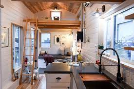 The cedar slab desk doubles as the headboard when the bed is lowered. 304 Sqft Kootenay Tiny House On Wheels For Family Of 3 By Tru Form Tin Dream Big Live Tiny Co