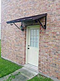 The Classic Metal Door Awning In Bronze With The Single S Scrolls Door Awnings Custom Awnings Garage Door Design
