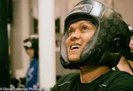 The third 'man' in the boxing ring is actually a woman...