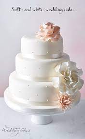 A Three Tier Cake Of Golden Sponge With Raspberry Jam And Buttercream Filling Covered In Ivory Soft Icing And Dec Wedding Cake Cookies Cake Cool Wedding Cakes