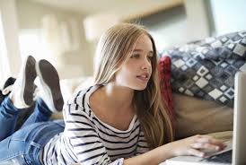 Woman with laptop on the green grass. 5 Common Questions About A Girl S First Periods