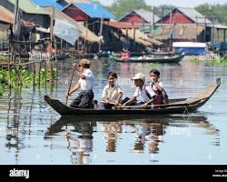 Image of Children playing on a boat in a floating village in Cambodia