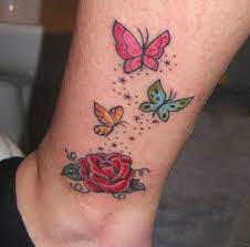 If you like the look of a tattoo armband but want to take advantage of even floral tattoos don't have to be dainty and delicate; Colorful Butterflies And Rose Flower Tattoo On Leg