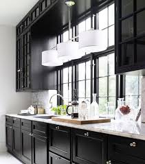 Modern farmhouse kitchen with white cabinets and black countertops. Black And White Kitchens Freshsdg