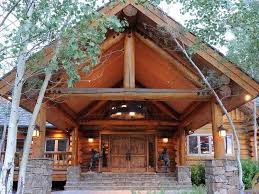 Examine the sides of the door in the wall of a log cabin with walkout basement to determine the material composition of the foundation wall. 9 Enormous Log Cabin Mansions For Sale