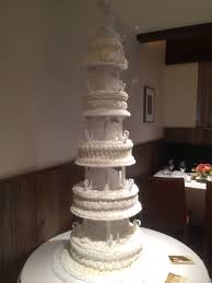 I love the single plate stacking system by bakers craft and i was assuming i could just cut the pillars 3 inches taller than each tier and put the roses in the gap. 1970 S Style Tiered Wedding Cake With Pillars And Bows Buttercream Cakecentral Com