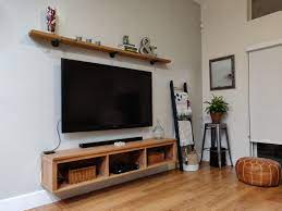 Check out our tv shelf selection for the very best in unique or custom, handmade pieces from our home & living shops. Wall Mounted Tv Floating Entertainment Unit And Wood Shelf Above The Tv Woodshelf Wall Shelf Decor Living Room Living Room Inspo Shelf Above Tv Living Room