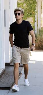 Black And White Shorts Outfit Men Niall Horan With A Summer Outfit Idea With A Black T Shirt Tan Shorts Black Leather Banded Watch Su Summer Outfits Men Spring Outfits Casual Spring Outfits Men